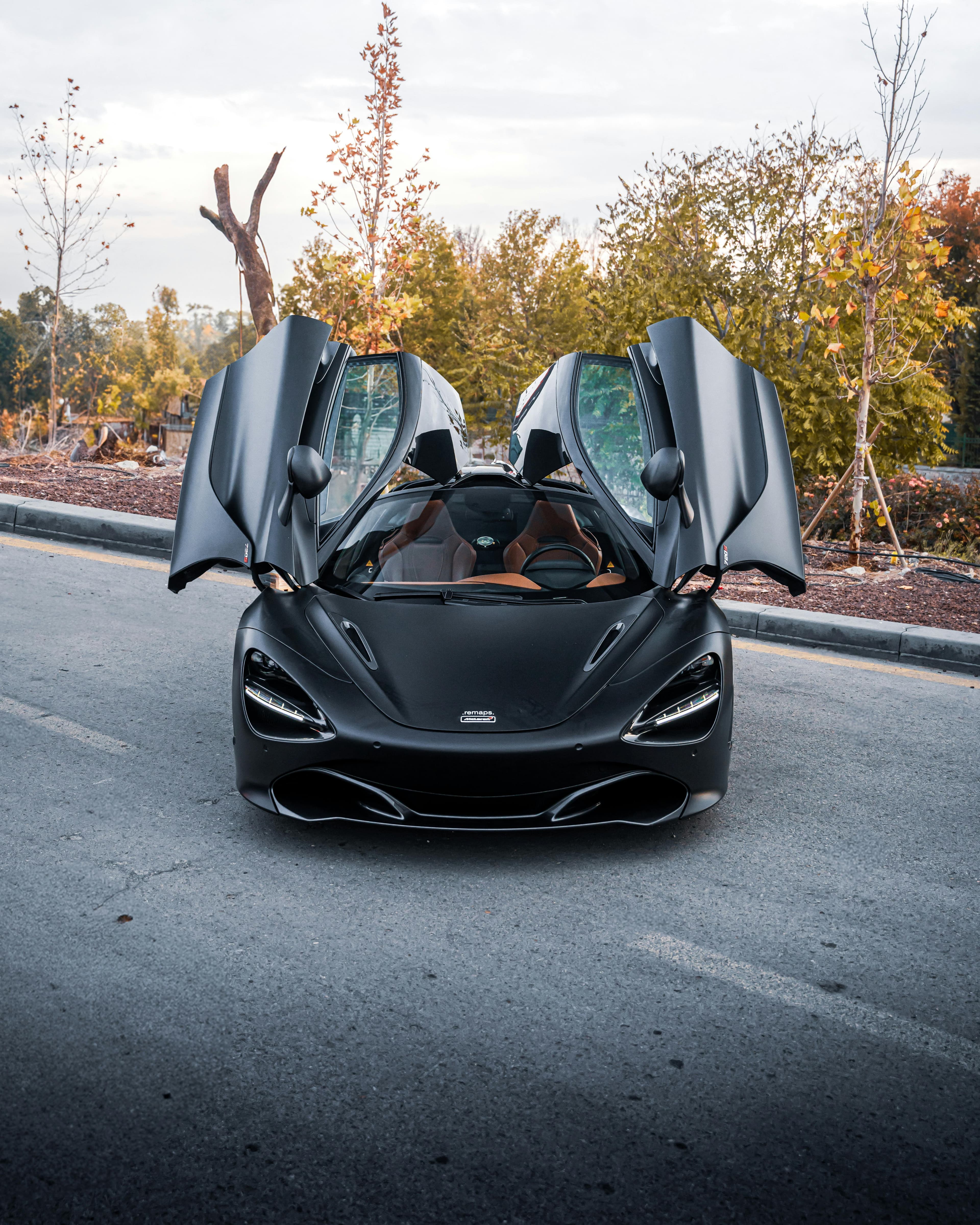 Black McLaren 720S with butterfly doors open