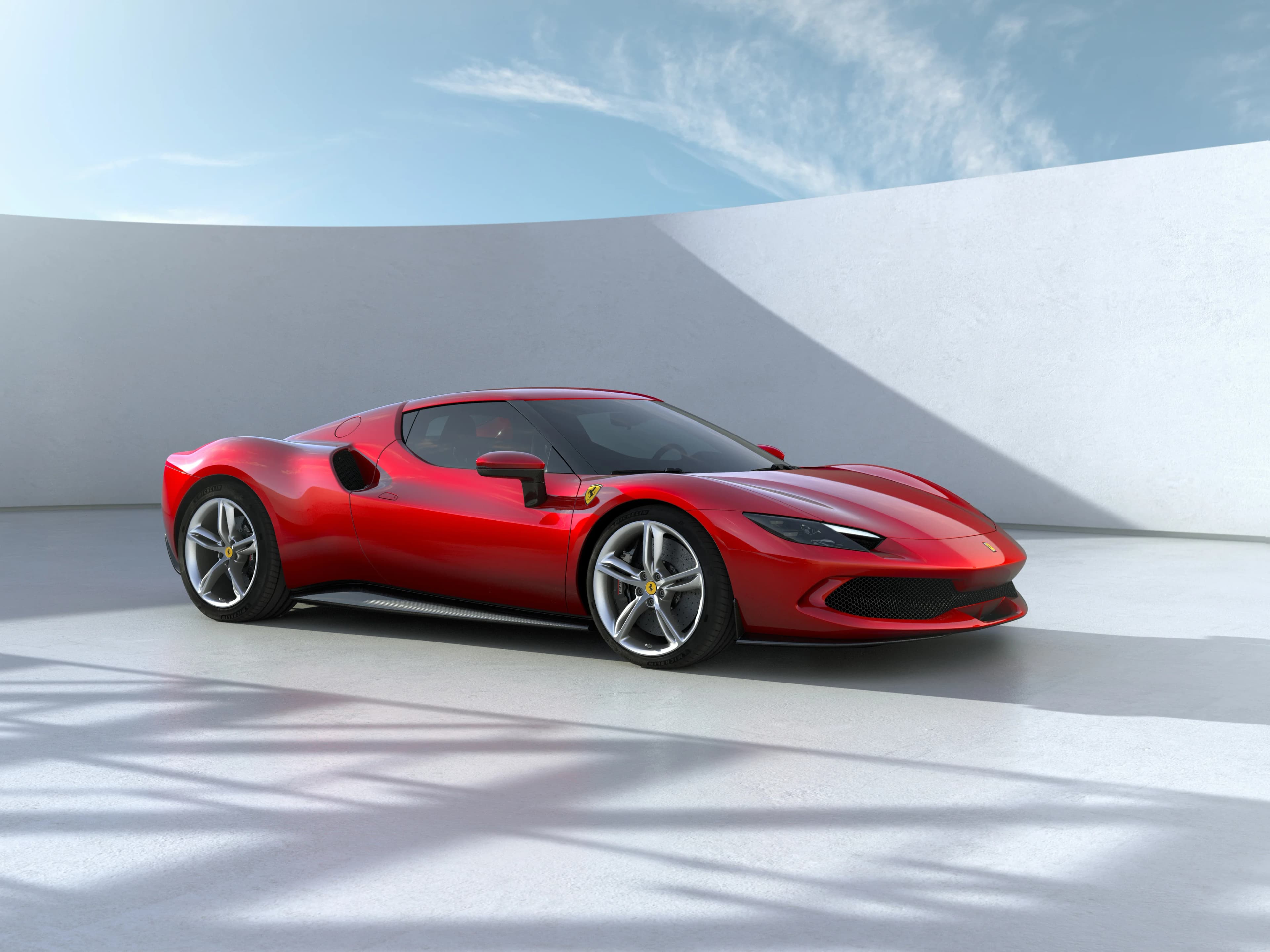 Red Ferrari 296 GTB in a sleek studio-like setting