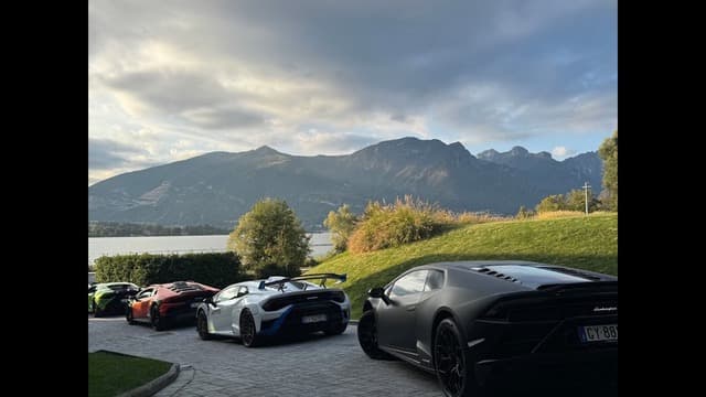 Supercar on a mountain road above a lake